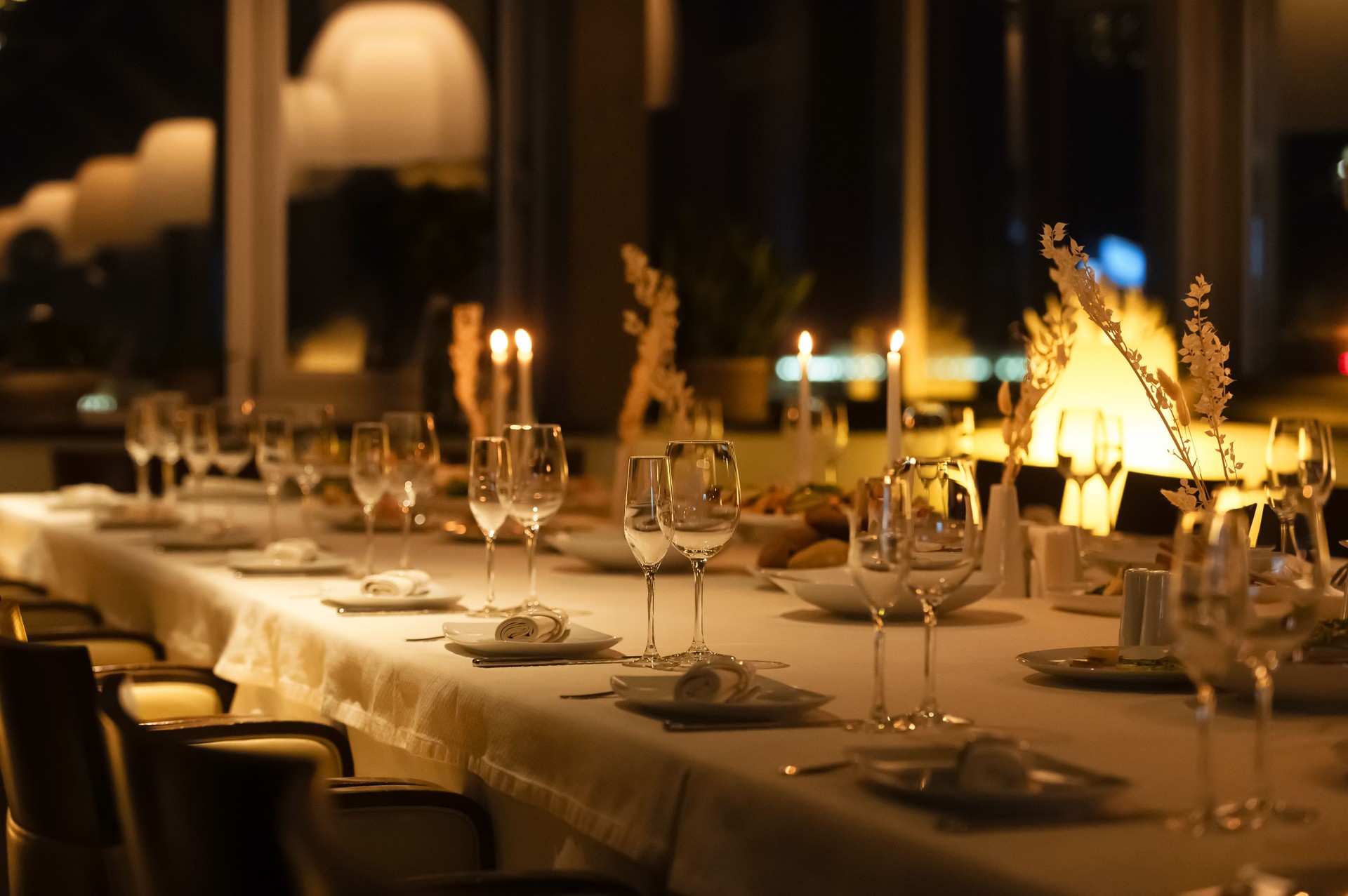 Elegant dining setup with candles at night in a stylish restaurant